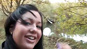Dark-haired babe is in nature with her partner and he wishes his cock licked